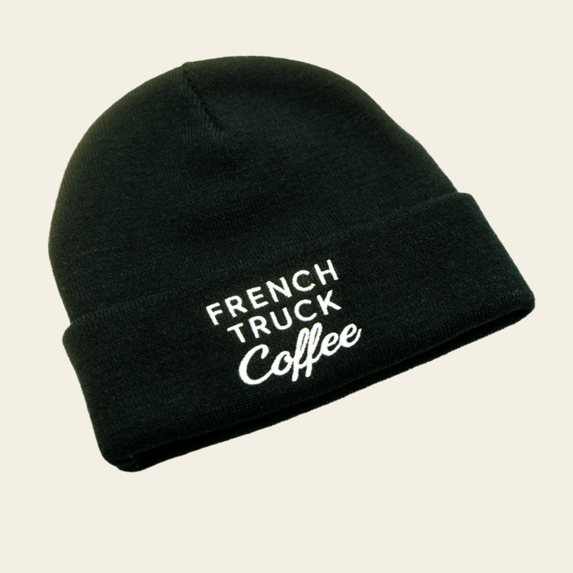 Black knit beanie with white French Truck Coffee logo, ideal for cold days